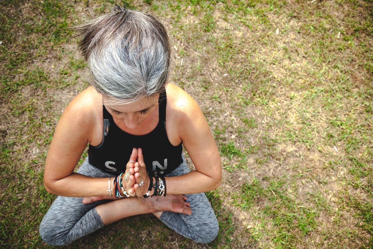 Mature woman performing gentle stretching exercise in wellness studio
